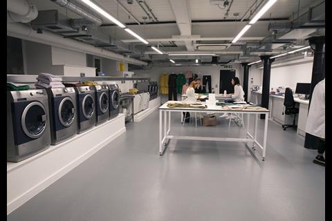 Interior of Boohoo Lab Manchester showing staff in white coats and washing machines